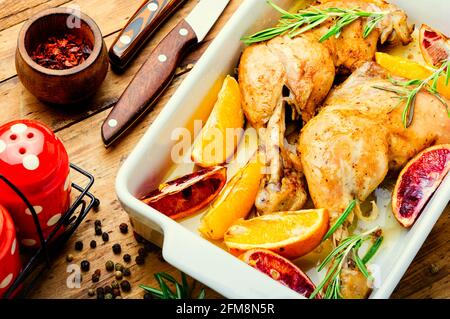 Viande de poulet grillée avec sauce à l'orange et romarin dans un plat de cuisson Banque D'Images