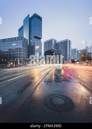 Circulation aux heures de pointe dans les bureaux éclairés de Leipziger Strasse dans la soirée à Berlin. Banque D'Images