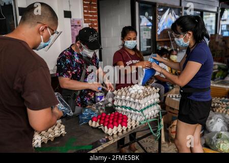 Des bénévoles préparent des dons alimentaires à un garde-manger communautaire dans le quartier de Maginhawa à Quezon City. Malgré les allégations des agents de la loi en tant qu'organisations communistes souterraines qui veulent saper le gouvernement, des pantares communautaires ont germé à travers le pays la semaine dernière pour aider les personnes touchées par des mesures strictes de quarantaine afin de freiner la propagation de la coronavirus. Metro Manille, Philippines. Banque D'Images