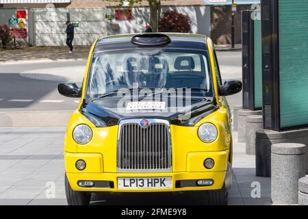 Taxi londonien jaune et noir à Imperial Wharf, Chelsea Harbour, Sands End, Borough of Hammersmith and Fulham, Greater London, Angleterre, Royaume-Uni Banque D'Images