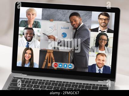 Écran d'ordinateur portable avec des professionnels multiculturels ayant des réunions virtuelles, gros plan Banque D'Images