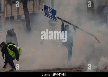 Les manifestants s'opposent à la police près de l'Arc de Triomphe pendant le quatrième samedi des manifestations nationales par le mouvement des « gilets jaunes » dans la ca Banque D'Images