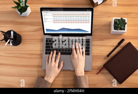 Femme méconnue travaillant sur un ordinateur portable, analysant les actions et les marchés Banque D'Images