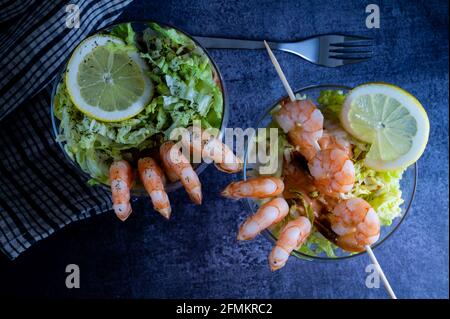 Entrée de cocktail de crevettes fraîches servie dans un restaurant touristique tropical dans un verre avec décoration de crevettes avec sauce maionaise, citron, laitue et alcôh Banque D'Images