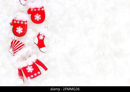 Flat Lay rouge vif vêtements de Noël Père Noël sur fond blanc de neige artificielle avec espace de copie. Fête de Noël et du nouvel an co Banque D'Images