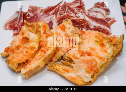 Une portion de la meilleure qualité de jambon cru ibérique accompagné par des toasts de pain faits maison Banque D'Images