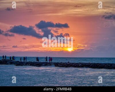 Coucher de soleil sur le golfe du Mexique avec les gens sur le north Jetty à Nokomis Floride Etats-Unis pris du sud Ou sur la jetée de Venise Banque D'Images