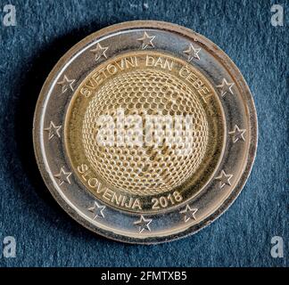 Côté national de deux pièces en euros émises par la Slovénie isolées sur fond noir. Édition spéciale de la Journée mondiale des abeilles 2018 Banque D'Images
