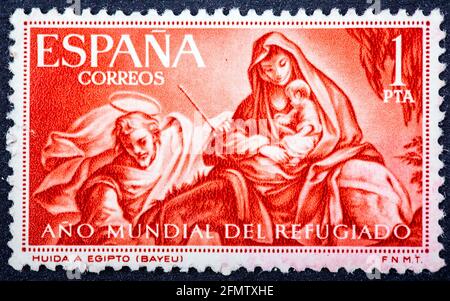 ESPAGNE - VERS 1961: Un timbre imprimé en Espagne du numéro de l'année mondiale des réfugiés montre le vol vers l'Égypte (après Bayeu), vers 1961. Banque D'Images