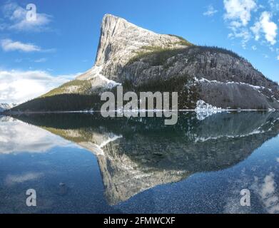 Ha Ling Mountain Peak se reflète dans l'eau bleue calme du lac Whiteman Gap au-dessus de Canmore. Alberta Foothills Canadian Rockies Paysage scénique du printemps Banque D'Images