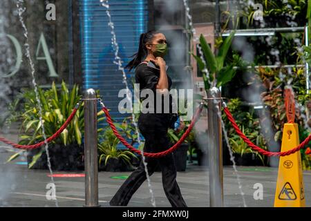 Kuala Lumpur, Malaisie. 12 mai 2021. Une femme portant un masque facial marche dans une rue à Kuala Lumpur, en Malaisie, le 12 mai 2021. Selon le ministère de la Santé, la Malaisie a enregistré mercredi son plus grand nombre de décès d'un jour par rapport à la COVID-19, après que le virus ait fait 39 morts de plus, portant le nombre total de décès à 1,761. Credit: Chong Voon Chung/Xinhua/Alay Live News Banque D'Images