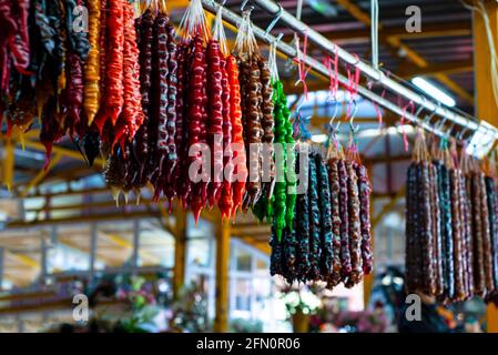 Churchkhela au bazar. Sucreries orientales colorées à base de noix et de jus naturel. Banque D'Images