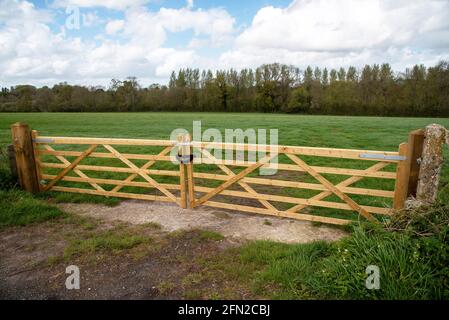 Hampshire, Angleterre, Royaume-Uni. 2021. Portes doubles à cinq barres verrouillées et sécurisant un champ de fermiers dans la campagne du Hampshire, Angleterre, Royaume-Uni Banque D'Images