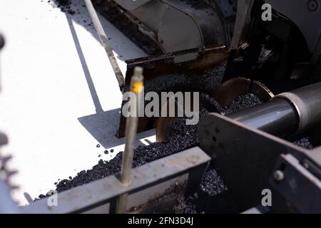 Rouleau d'asphalte lourd moderne qui empilent et presse l'asphalte chaud. Machine de réparation sur route jaune. Réparation dans une ville moderne avec un compacteur à rouleaux à vibrations Banque D'Images