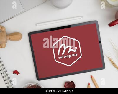 Vue de dessus de la tablette numérique maquette sur le plan de travail avec papeterie et fournitures Banque D'Images