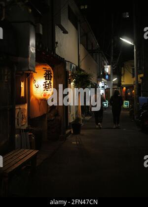 Lanterne japonaise dans la ville la nuit. Une lanterne rouge suspendue devant un restaurant. Banque D'Images