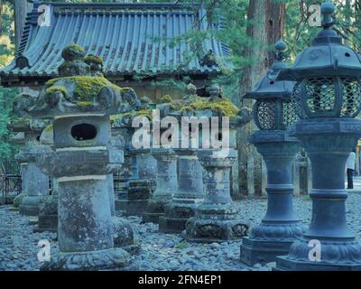 Lanternes japonaises en pierre alignées. Lanternes anciennes en pierre avec mousse verte sur le dessus. Tradition japonaise et style baroque. Banque D'Images