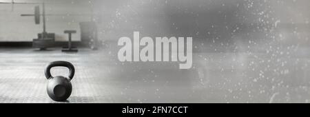 Composition de kettlebell sur le sol de la salle de sport avec lumière grise floue Banque D'Images