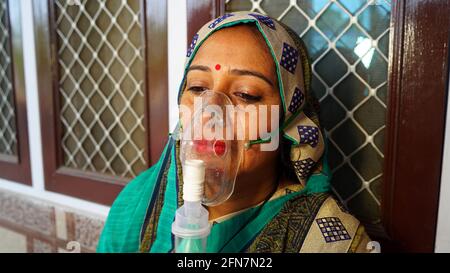 03 mai 2021 - Reengus, Sikar, Inde. Femme souffrant de la maladie de Covid 19. Jeune femme admise à l'hôpital et inhalant de l'oxygène d'urgence avec une canule Banque D'Images