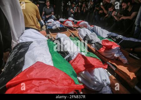 Gaza, Territoires palestiniens. 15 mai 2021. Les Palestiniens assistent aux funérailles de la famille Abu Hatab à Gaza. Huit enfants et deux femmes, tous appartenant à la famille Abu Hatab, ont été tués dans le bâtiment de trois étages du camp de réfugiés de Shati qui s'est effondré à la suite d'une grève israélienne, ont indiqué des sources médicales. Credit: Mohammed Talatene/dpa/Alay Live News Banque D'Images