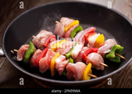 Brochettes de poulet cuisant dans une casserole. Photo de haute qualité. Banque D'Images