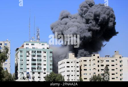 Gaza, Gaza. 15 mai 2021. De la fumée s'affiche alors qu'une bombe à air est déposée dans la tour Jala lors d'une frappe aérienne israélienne dans la ville de Gaza samedi, le samedi 15 mai 2021 à Gaza. L'attaque a eu lieu environ une heure après que l'armée israélienne ait ordonné au peuple d'évacuer le bâtiment, qui abritait également Al-Jazira et un certain nombre de bureaux et d'appartements. Il n'y avait pas d'explication immédiate pour la raison pour laquelle le bâtiment était visé. Photo par Ahmad Zaqut/UPI crédit: UPI/Alamy Live News Banque D'Images