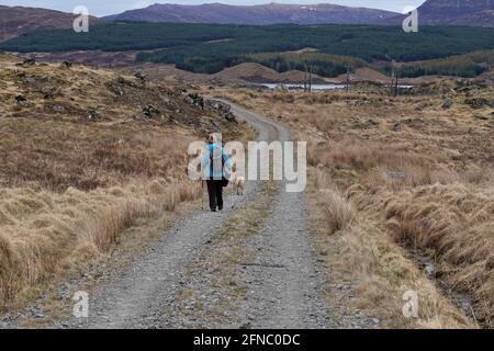 Femme solitaire sur @Road vers le chemin des îles de Corrour À Rannoch Banque D'Images