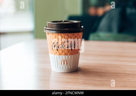 Odessa ,Ukraine - Mars 05 2021: Tasse de papier de café McDonald's sur une table en bois dans un café Banque D'Images