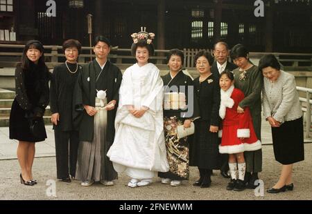 Mariée et marié avec invités de mariage devant le sanctuaire Meiji dans la capitale japonaise. [traduction automatique] Banque D'Images