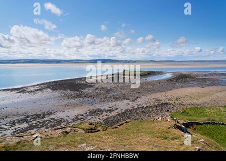 Des rives rocheuses de Lindisfarne, passez devant la minuscule île de St Cuthbert jusqu'à une campagne lointaine et brumeuse de Northumbrie. Banque D'Images