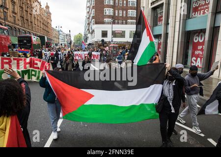 Londres, Royaume-Uni. 15 mai 2021. Les activistes marchent avec un drapeau palestinien alors que des centaines de personnes participent à un rassemblement de solidarité de la Palestine libre SOS Colombie et marchent de l'ambassade colombienne à l'ambassade israélienne. Les orateurs ont souligné les violations des droits de l'homme telles que le déplacement forcé contre les Palestiniens en Israël et dans les territoires occupés et le meurtre, la répression, la détention et la torture de manifestants pacifiques et de défenseurs des droits de l'homme en Colombie. Crédit : Mark Kerrison/Alamy Live News Banque D'Images