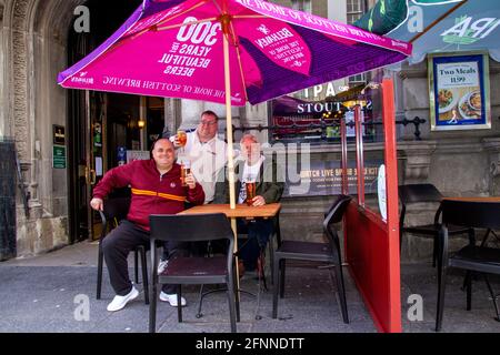 Dundee, Tayside, Écosse, Royaume-Uni. 18 mai 2021. Météo au Royaume-Uni : soleil de printemps chaud dans le nord-est de l'Écosse avec des températures atteignant 15°C. Les restrictions de verrouillage de Covid-19 sont désormais assouplies au niveau 2 à Dundee en voyant les gens profiter des nouvelles réglementations assouplies et en socialisant à l'intérieur et à l'extérieur des pubs locaux. Les restrictions de niveau 2 permettent aux pubs Dundee de rester ouverts jusqu'à 22 h 30 pour les clients qui apprécient le temps de boire au bar Old Bank dans le centre-ville. Crédit : Dundee Photographics/Alamy Live News Banque D'Images