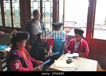 Nanning, Chine. 18 mai 2021. (210518) -- NANNING, 18 mai 2021 (Xinhua) -- Pan Jiping (2e, R) introduit des connaissances en prévention de pandémie au village de Xiaozhai, canton de Longji, comté de Longsheng, région autonome de Guangxi Zhuang, dans le sud de la Chine, le 18 mai 2021. À Xiaozhai, un village au pied de la montagne de Fupingbao à plus de 1,900 mètres d'altitude, Pan Jiping est médecin de campagne ici depuis plus de 30 ans. PAN, 57 ans, est l'un des Hongyao, une branche du groupe ethnique Yao. Banque D'Images