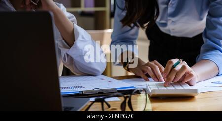 Pour l'enquête sur un compte de corruption, un groupe de femmes d'affaires et de comptables recherchent des documents de données sur un ordinateur portable. Définition de la lutte contre la corruption. Banque D'Images