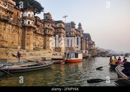 Varanasi, Inde - 01 novembre 2016: Personnes, pèlerins et touristes sur bateau en bois de visite dans le fleuve ganges contre l'extérieur et l'archit vieux bâtiment Banque D'Images