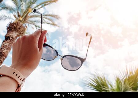 Les femmes tiennent des lunettes de soleil en gros plan Banque D'Images