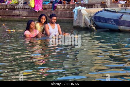 Varanasi, Inde - 01 novembre 2016 : une famille heureuse de Père et de filles qui exécutent la prière et le rituel hindou dans le fleuve Saint Gange Banque D'Images