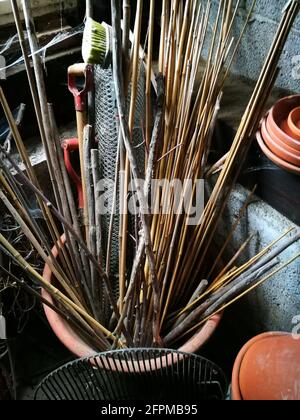 Gros plan vertical d'un seau de jardinage avec des bâtons en bois et outils Banque D'Images