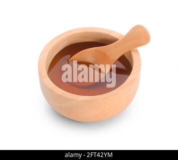 Miel avec bol en bois isolé sur fond blanc. Banque D'Images