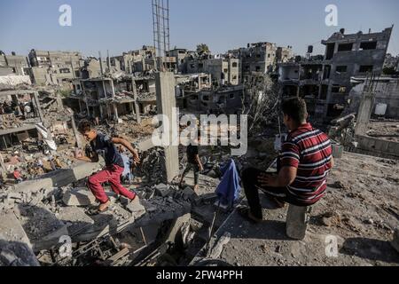 21 mai 2021, ville de Gaza, bande de Gaza, Palestine : les Palestiniens s'assoient parmi les décombres de leurs maisons détruites après le cessez-le-feu entre Israël et les militants de Gaza, dans la ville de Beit Hanoun, dans le nord de la bande de Gaza, le 21 mai 2021. Après 11 jours de combats, le cessez-le-feu est entré en vigueur entre Israël et les militants de la bande de Gaza, sous la supervision d'une initiative égyptienne visant à mettre fin à un incendie inconditionnel. Selon le Ministère palestinien de la santé, au moins 232 Palestiniens ont été tués lors de l'attaque israélienne, tandis qu'au moins 12 Israéliens ont été tués lors d'attaques à la roquette en provenance de Gaza. CRE Banque D'Images