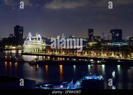 Rotterdam, pays-Bas. 19 mai 2021. Les bâtiments résidentiels et commerciaux du Maashaven dans le quartier Feijenoord avec l'ancien navire de croisière 'S Rotterdam', converti en hôtel, dans le bras de la rivière Nieuwe Maas. Le navire a été utilisé dans le service de paquebot entre Rotterdam et New York avec une escale au Havre et est un hôtel et un navire de musée depuis 2009. Credit: Soeren Stache/dpa-Zentralbild/dpa/Alay Live News Banque D'Images