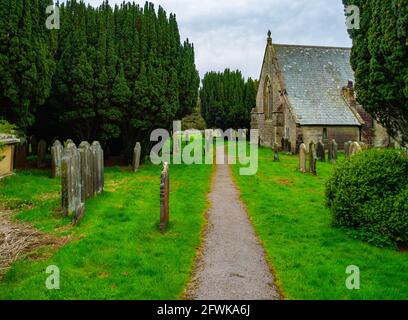 Entrée à l'église de St Hilda Danby, dans le North Yorkshire, Royaume-Uni à Danby Dale construite sur un ancien cimetière pré-chrétien avec des arbres de Yew matures et de vieilles tombes Banque D'Images