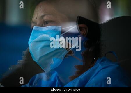 Katmandou, Népal. 23 mai 2021. Réflexion d'un professionnel de la santé qui a recueilli l'écouvillon de gorge d'un homme pour le test de réaction en chaîne de polymérase (PCR) en raison de préoccupations au sujet de la propagation de la deuxième vague de coronavirus, COVID-19 pandemicNepal's COVID-19 nombre de décès atteint 6,347 avec 193 nouveaux décès. (Photo de Prabin Ranabhat/SOPA Images/Sipa USA) crédit: SIPA USA/Alay Live News Banque D'Images