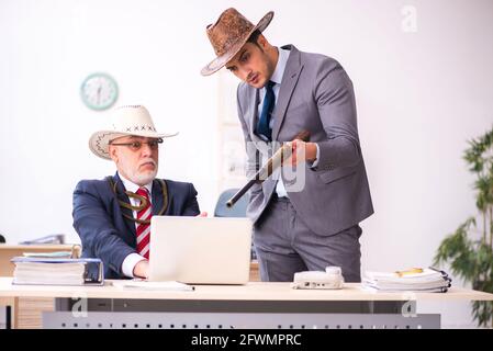 Deux employés de cow-boy dans un concept drôle Banque D'Images