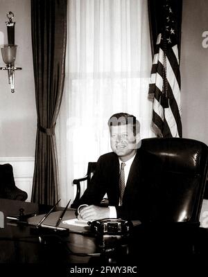 Photo portrait du Président John F. Kennedy à son bureau dans le Bureau ovale de la Maison Blanche, Washington, D.C. il s'agit de la première photo de la Maison Blanche faite du Président à son bureau. Banque D'Images