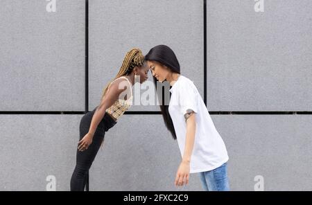 Des amies penchées par le mur Banque D'Images