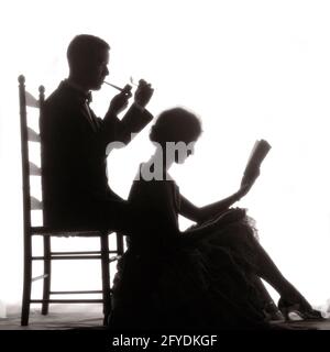 SILHOUETTE DE DOMESTICITÉ DES ANNÉES 1920 D'HOMME DE COUPLE ANONYME ASSIS DANS LA CHAISE UN TUYAU D'ÉCLAIRAGE ET UNE FEMME ASSISE À SES FRAIS LISANT UN LIVRE - S1333 HAR001 FEMMES HARS MARIÉE STUDIO SHOT CONJOINT MARIS SANTÉ MAISON VIE COPIE ESPACE AMITIÉ PLEINE LONGUEUR DAMES PERSONNES SOINS MASCULINS SÉRÉNITÉ SILHOUETTES CONFIANCE B&W CONTOUR PARTENAIRE RÊVES BONHEUR BIEN-ÊTRE LOISIRS VICTOIRE SILHOUETTED HAUT DE GAMME PUISSANT DOMESTICITÉ CONNEXION CONCEPTUEL RICHE CONTENU ÉLÉGANT ANONYME FANTAISISTE IDYLLIQUE MI-ADULTE MI-ADULTE HOMME MI-ADULTE FEMME MI-ADULTE DÉTENTE TOGETHNESS BIEN-À-FAIRE FEMMES NOIR ET BLANC HAR001 Banque D'Images