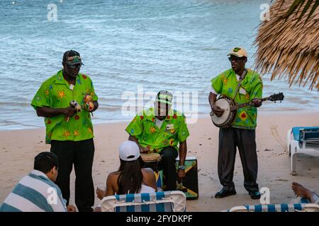 MONTEGO BAY, JAMAÏQUE - 09 JANVIER 2017: Trois musiciens jamaïcains sur la plage jouant mento - musique populaire jamaïcaine, ils jouent sur le banjo, la batterie et Banque D'Images