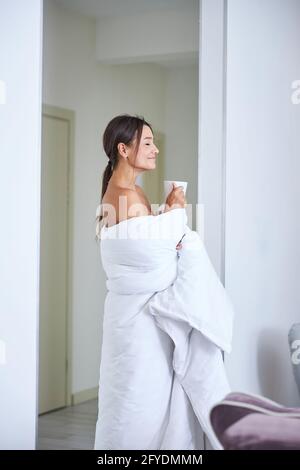 Bonne joyeuse femme caucasienne appréciant la nouvelle journée dans l'appartement confortable Banque D'Images