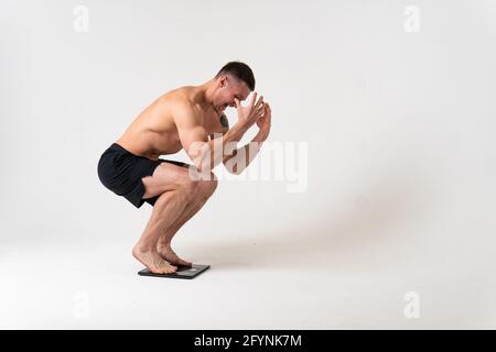 Homme avec des poids santé ponsé, santé et sports sur un fond blanc douleur mal, mal de dos maladie de fond médecine, chronique. Soins, maladie Banque D'Images